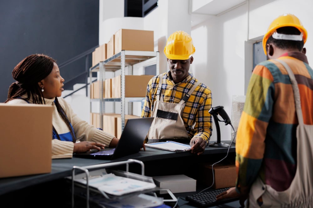 hipment-manager-asking-warehouse-workers-about-merchandise-storage-system-african-american-storehouse-employees-talking-using-inventory-rfid scanner-software-laptop-reception