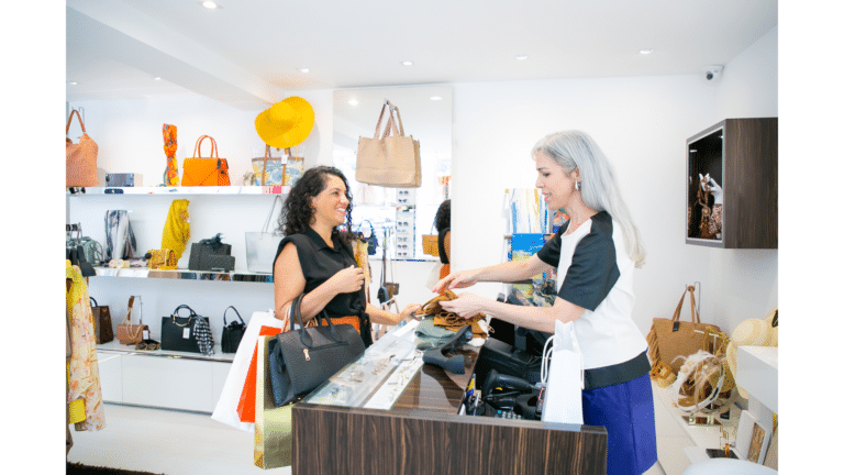 A clothing store owner remove EAS tags and give cloths to a customer