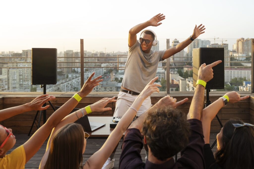 people wearing yellow color rfid labeled hand band with a barcode placing his hand on a RFID scanner and entered  to a musical show and enjoying the music