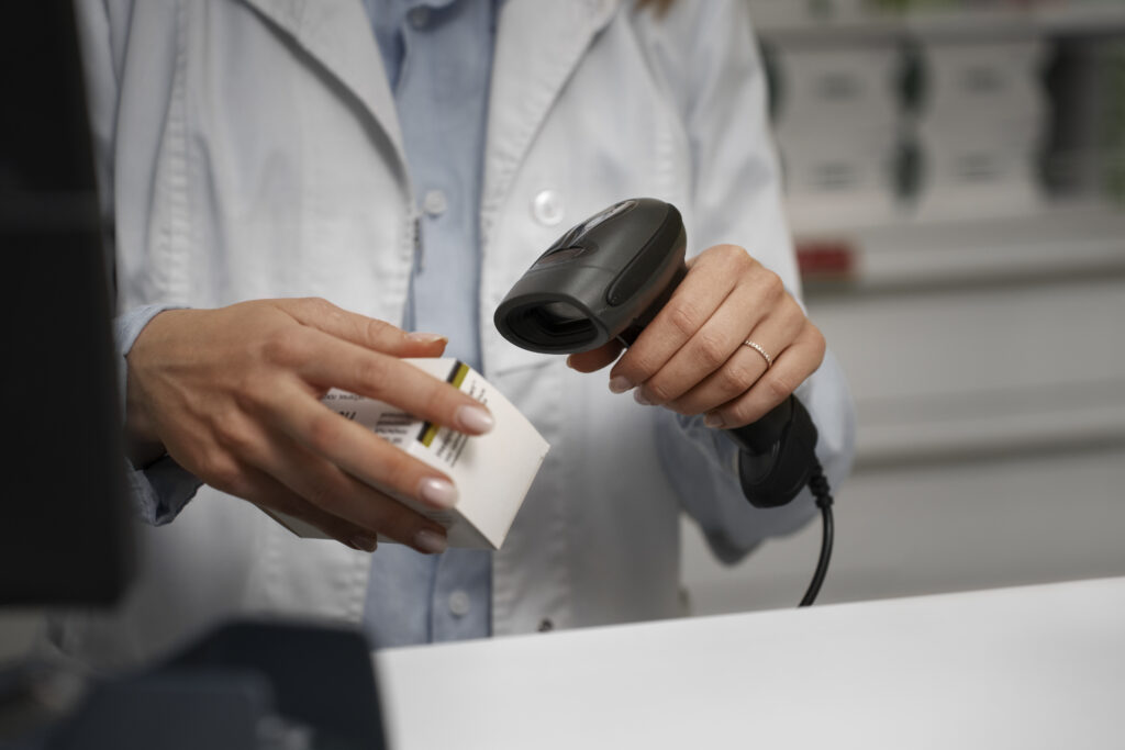 Female pharmacist scanning medicine at the counter using handheld RFID scanners